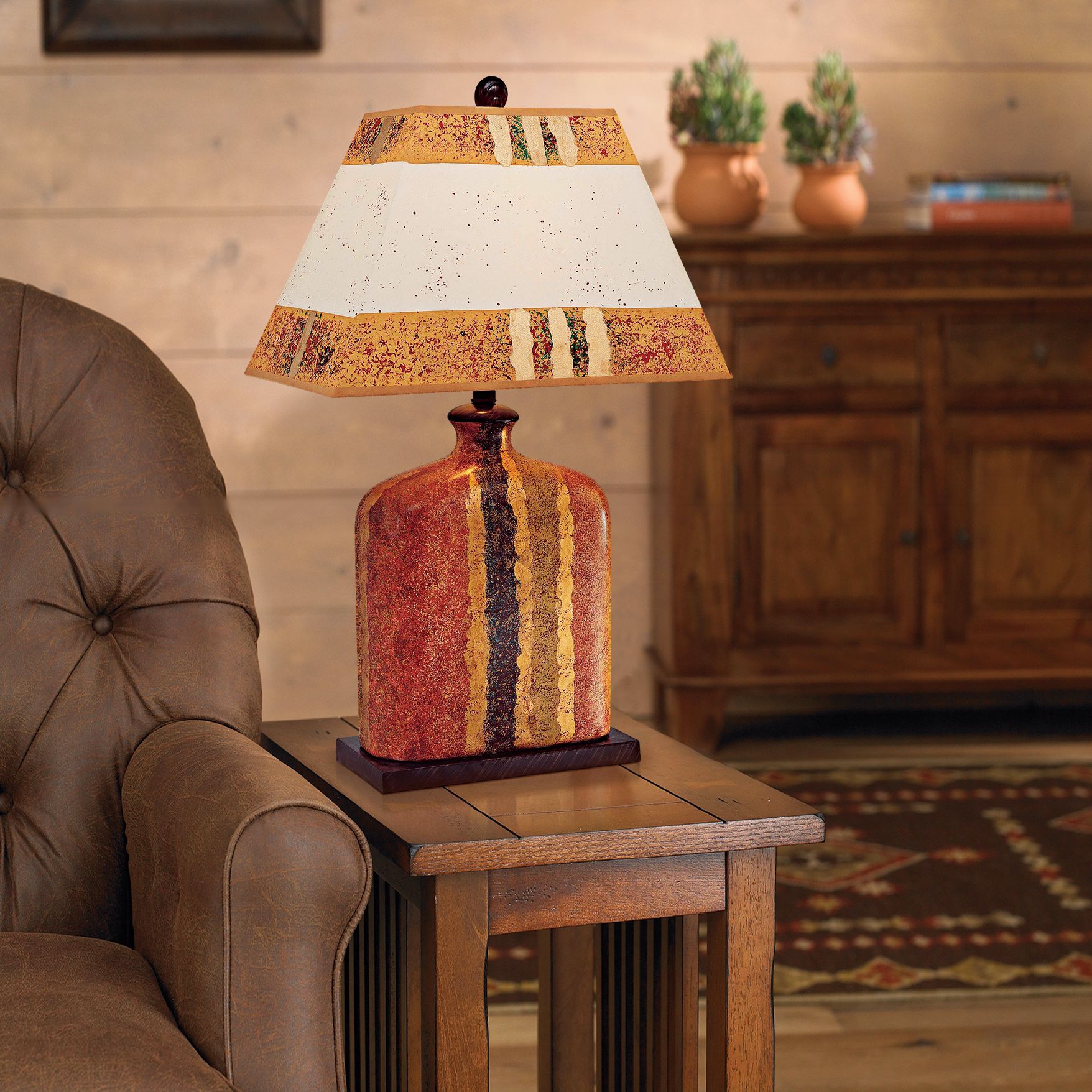 A hand painted ceramic lamp makes a colorful statement in a rustic living room.